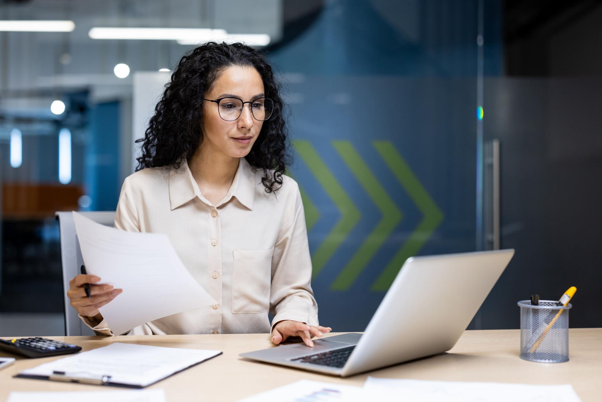 Nonprofit compliance consultant reviewing documents and preparing to support a client online
