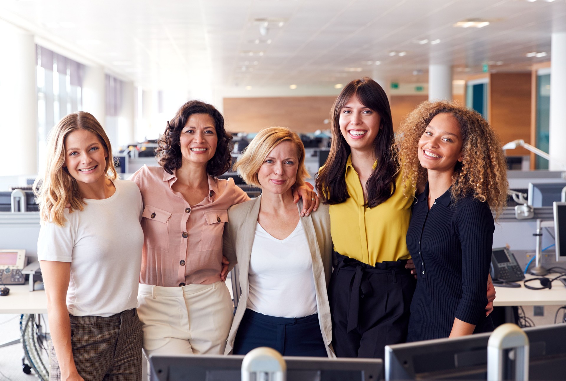 Diverse team of professional women in an office representing nonprofit support and compliance services